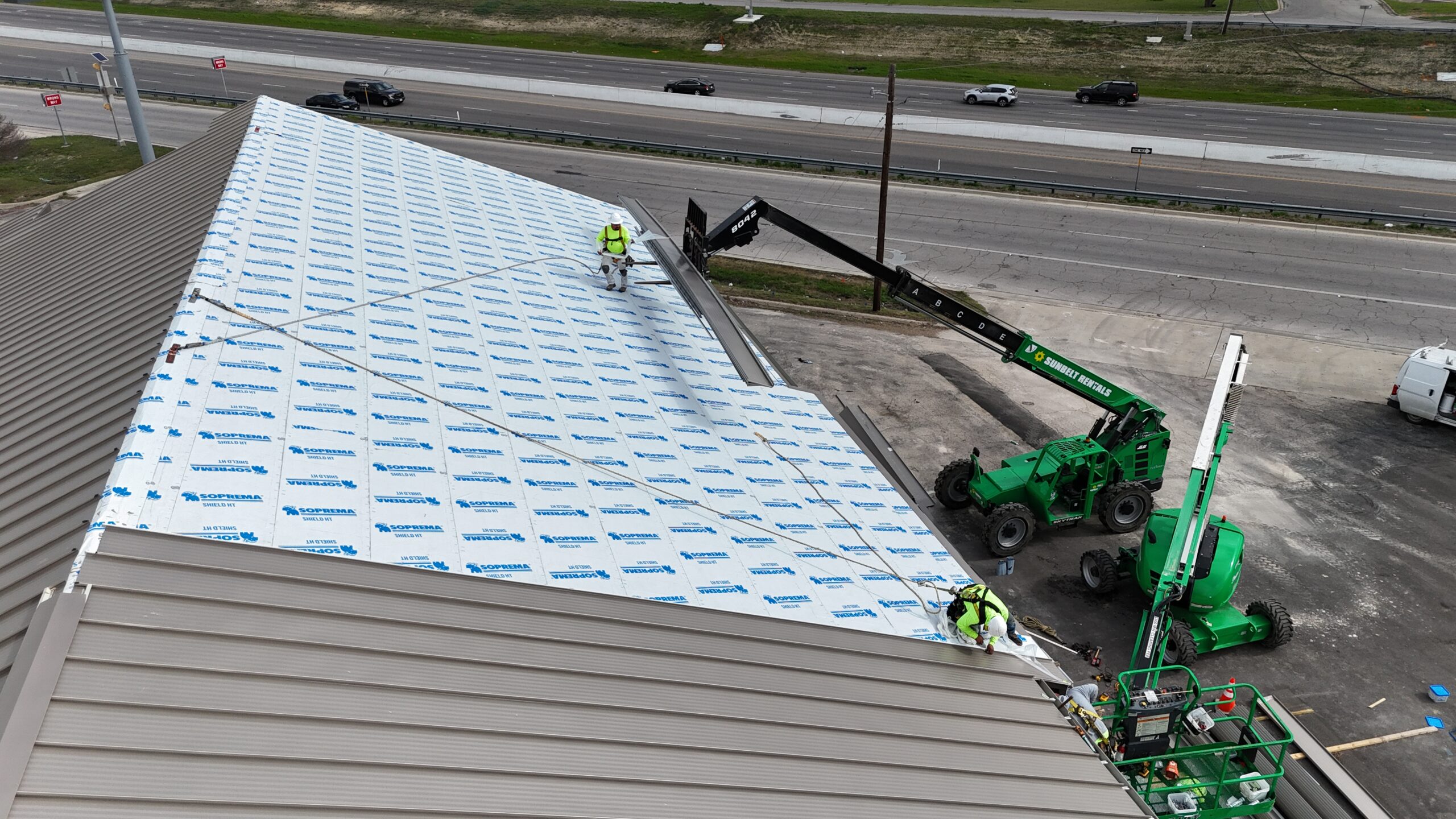 Commercial metal roofing construction in progress by Monarch Texas Contracting in Dallas, TX.