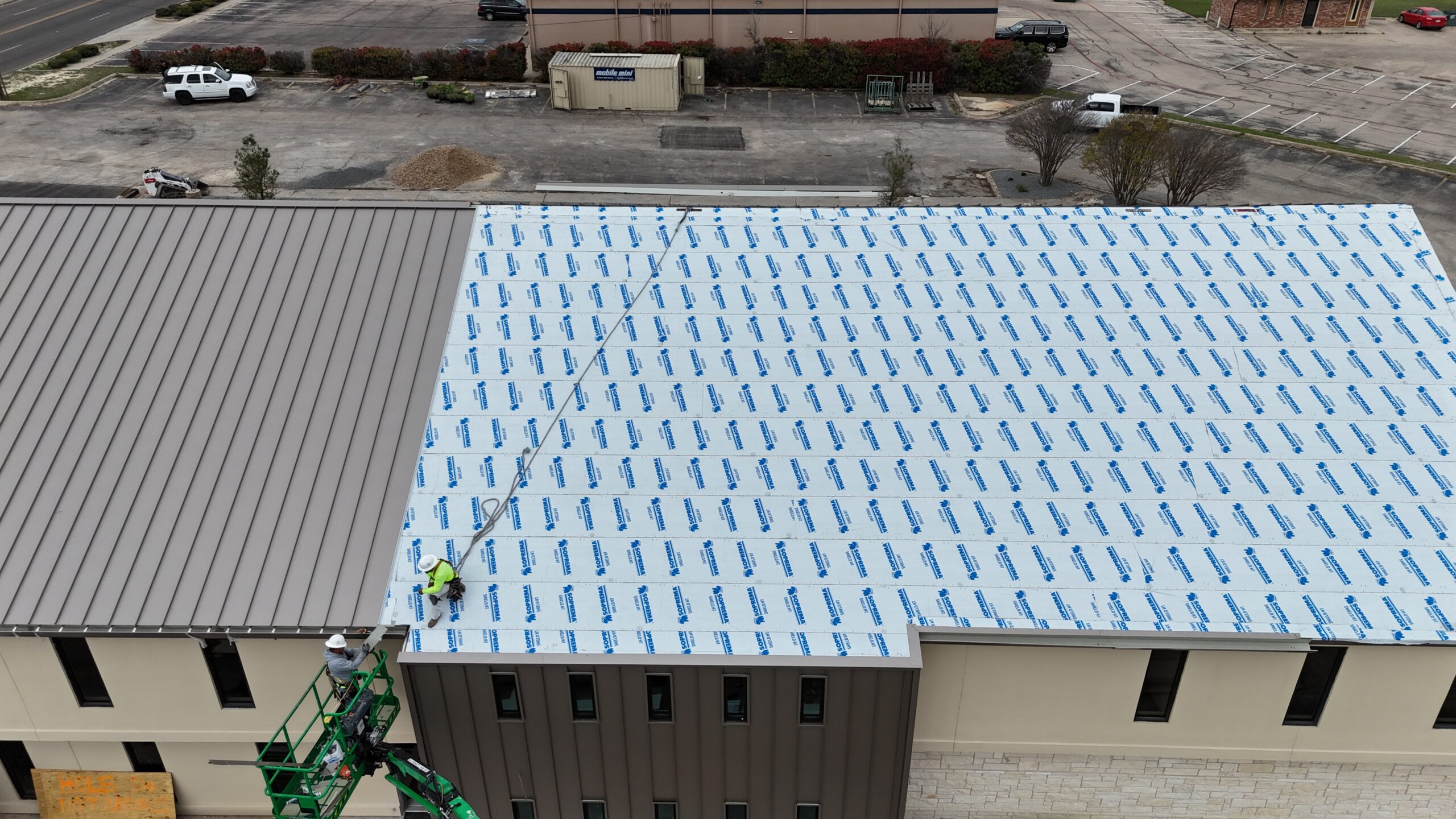 Commercial roofing underlayment installed before standing seam metal roofing in Dallas, TX.