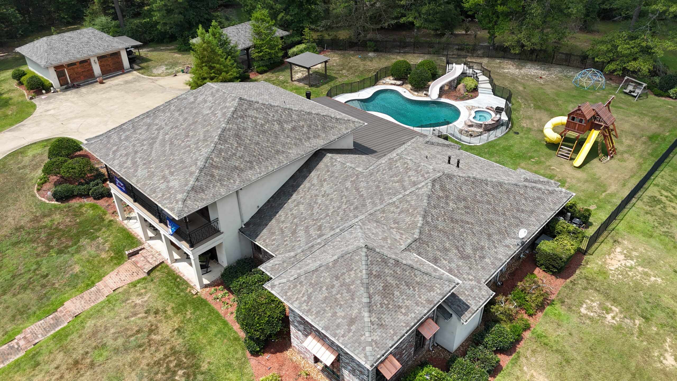 Drone view of a completed residential roof replacement by Monarch Texas Contracting in Dallas, TX.