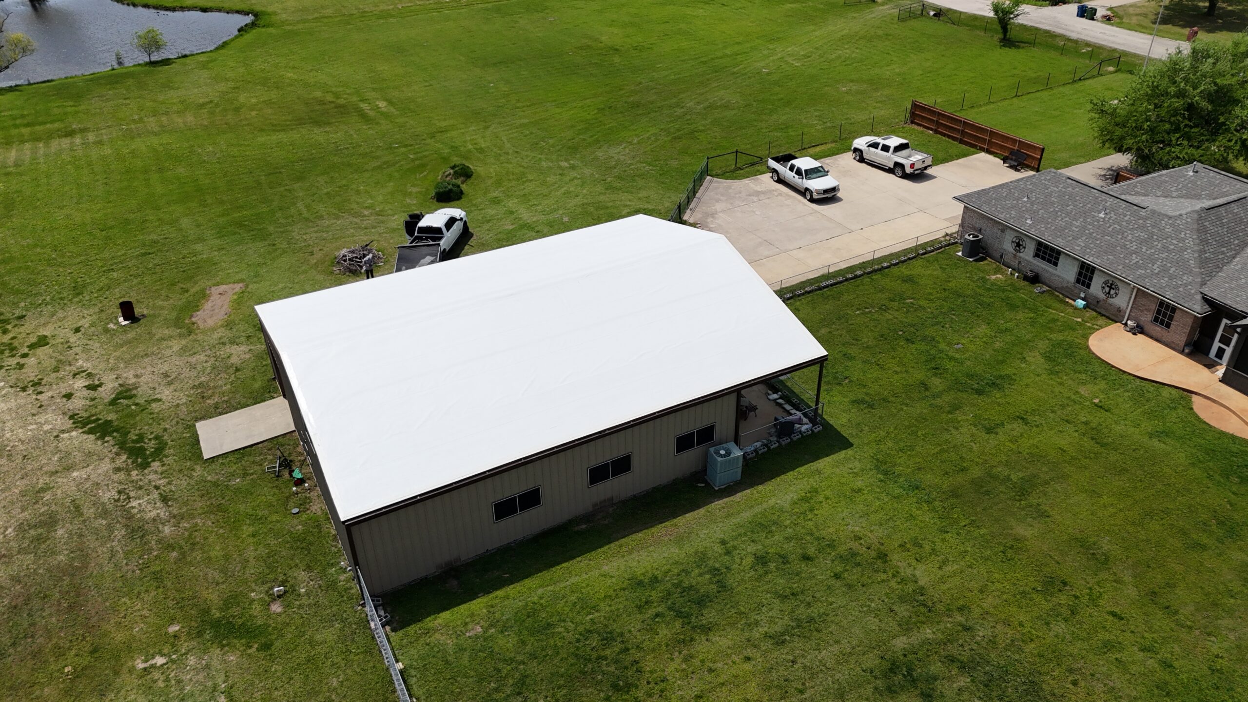 Steel building with a newly installed metal roofing system by Monarch Texas Contracting serving Dallas, TX.