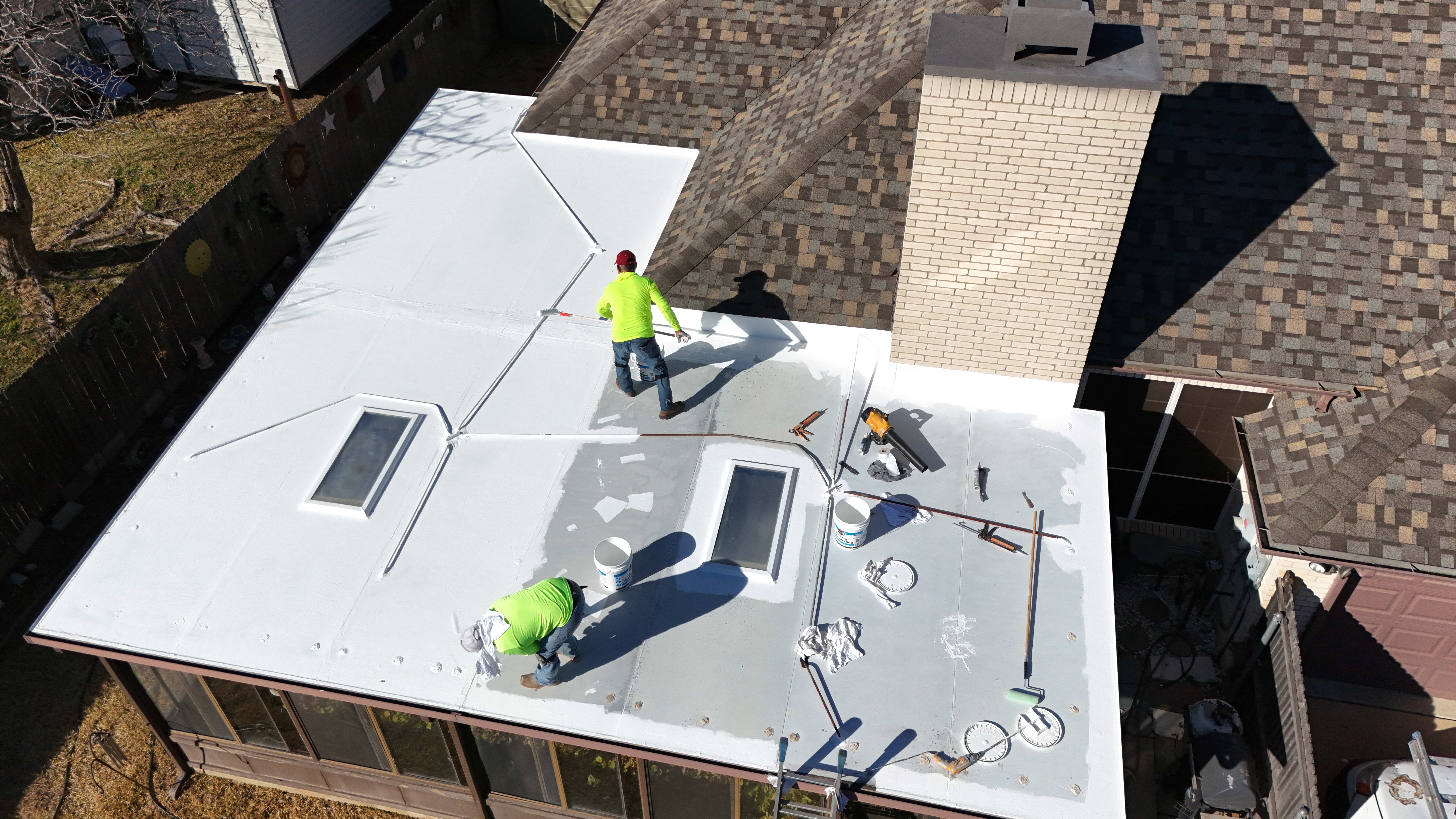 Roofing crew completing a residential flat roof installation in Dallas Fort Worth.
